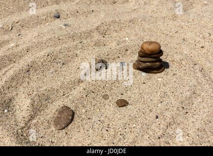 Multicolor stones and shells on a sand Stock Photo