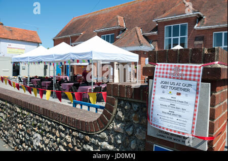 A poster outside a village hall advertising a community cream tea party in Wick Village, Littlehampton, England. The event formed part of The Great Get Together, a weekend of events held across the UK in memory of the murdered MP Jo Cox. Stock Photo