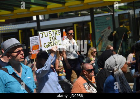 Manchester, UK. 17th June, 2017. Protestors take part in a march against the Tory-DUP government with placards and posters. ‘Justice for Grenfell: Tories Out, No DUP’ protest organised by members of the Socialist Worker’s Party, Labour Party and Jeremy Corbyn supporters in Manchester Albert Square on Saturday 17th June 2017. Credit: Pablo O'Hana/Alamy Live News