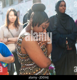 London, United Kingdom. 17th June 2017. A woman crying as they bring flowers, in the aftermath of the June 14 Grenfell Tower block fire, in Kensington, west London. Michael Tubi / Alamy Live News Stock Photo