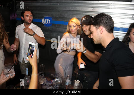 Watford, UK. 18th June, 2017. Jon Clark, Myles Barnett & Chris Clark partying at Hydeout Nightclub Watford. Jon was seen heavily flirting with a pretty blonde partygoer and wanted her to give him her number. She initially declined but later on  she gave in to his advances and the pair exchanged numbers. Jon and the girl heavily flirted spending most of the night together. The boys enjoyed bottles of vodka, whiskey and champage. Myles sprayed champagne on revellers but held back from flirting telling everyone his girlfriend is 'the love of my life' Credit: Ayeesha Walsh/Alamy Live News Stock Photo
