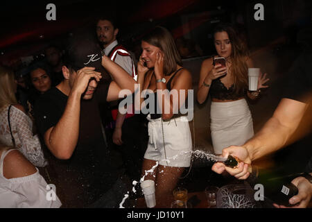 Watford, UK. 18th June, 2017. Jon Clark, Myles Barnett & Chris Clark partying at Hydeout Nightclub Watford. Jon was seen heavily flirting with a pretty blonde partygoer and wanted her to give him her number. She initially declined but later on  she gave in to his advances and the pair exchanged numbers. Jon and the girl heavily flirted spending most of the night together. The boys enjoyed bottles of vodka, whiskey and champage. Myles sprayed champagne on revellers but held back from flirting telling everyone his girlfriend is 'the love of my life' Credit: Ayeesha Walsh/Alamy Live News Stock Photo