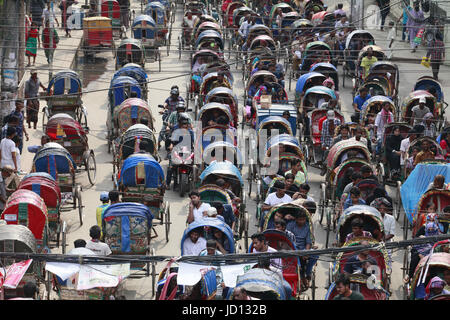 Dhaka, Bangladesh. 18th June, 2017. Hundreds of rickshaws are stuck in a jam on Dhanmondi in Dhaka, Bangladesh, June 18, 2017. Every year this very street sees a high number of the non-motorized vehicle ahead of Eid when the number of illegal rickshaws on city streets increases. About two lakh additional rickshaws have hit the city streets ahead of Eid-ul Fitr, causing massive traffic snarl-ups, with law enforcers opting to ignore the issue on what they unofficially say are humanitarian grounds. Credit: ZUMA Press, Inc./Alamy Live News Stock Photo