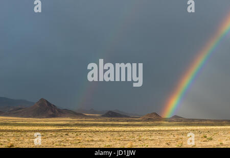 Rainbow over the desert near Coaldale, Nevada. Stock Photo