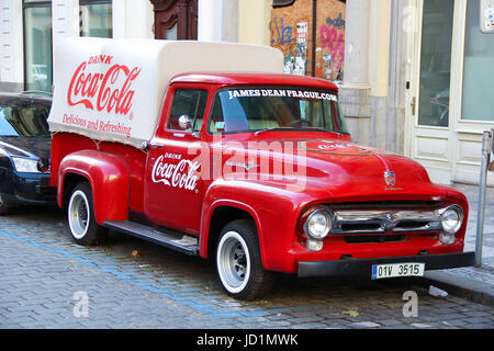 An old renovated red Ford vintage Coca cola truck (pickup) in a parking lot Stock Photo