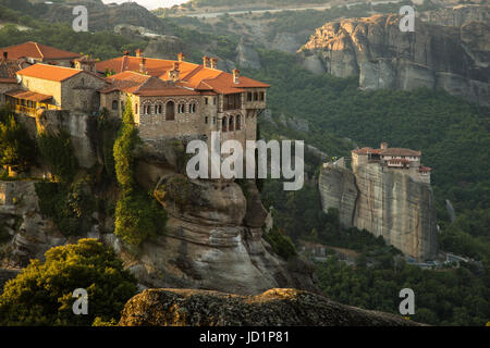 Meteora monasteries. Beautiful morning view on the Holy Monastery of Varlaam placed on the edge of high rock, Roussanou Monastery on background. Kastr Stock Photo