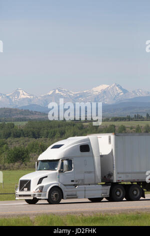 Truck in front of the Canadian Rockies in Alberta, Canada. The vehicle is on the Trans-Canada Highway. Stock Photo