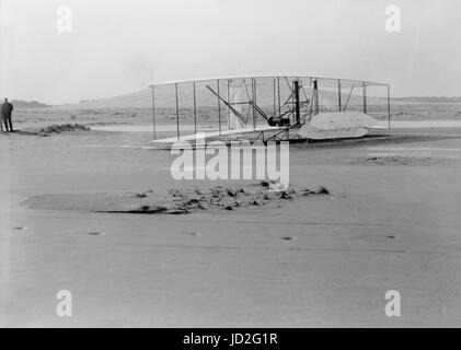 Close-up view of damaged 1903 machine, rudder frame broken in landing, on ground at end of last flight. Stock Photo