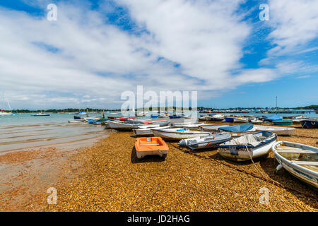 Rowing boats moored on the shoreline at West Itchenor, a small village in Chichester Harbour near Chichester on the south coast of England, UK Stock Photo