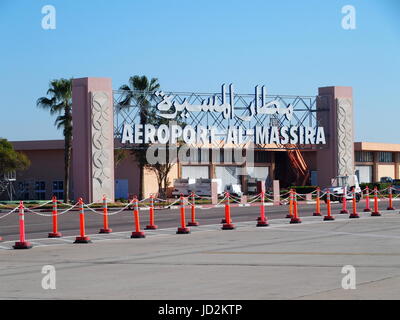 Entrance to airport in AGADIR city in MOROCCO with clear blue sky in 2017 warm sunny winter day. Arabic words means: Al Massira Airport, Africa. Stock Photo