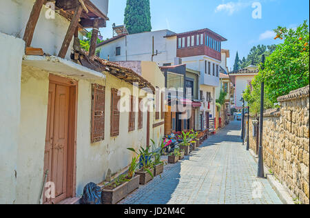 The narrow street in historic Kaleici neighborhood with outdoor cafes and souvenir shops, Antalya, Turkey. Stock Photo