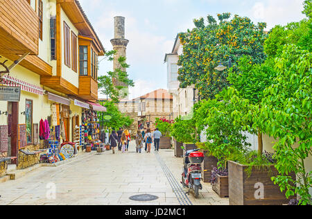 ANTALYA, TURKEY - MAY 6, 2017: The tourist street of Kaleici district with classical Ottoman houses and Kesik Minare Cami (Broken Minaret Mosque) on t Stock Photo