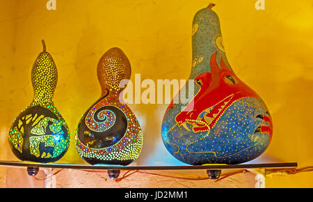 ANTALYA, TURKEY - MAY 6, 2017: The Eastern lamps and shades of dried pumpkin shells in stall of Old Bazaar decorated with colorful dragons, floral and Stock Photo