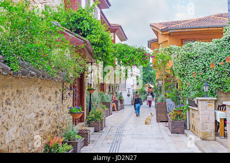 ANTALYA, TURKEY - MAY 6, 2017: The narrow streets of Kaleici are often decorated with shrubs and flowers in pots and trees in tubs, so this district l Stock Photo