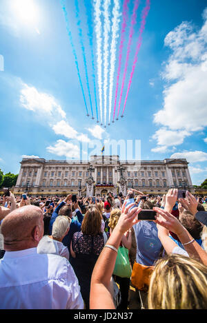 The Red Arrows passing over Buckingham Palace for the Queen's Birthday Flypast with crowds. London. Trooping the Colour Stock Photo