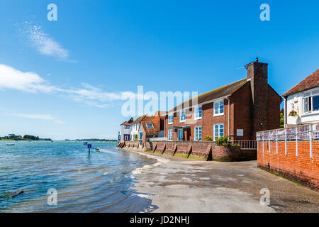 Rising tide flooding the seafront access road, Bosham, a south coast coastal village in Chichester Harbour, West Sussex, southern England, UK Stock Photo