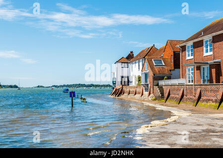 Rising tide flooding the seafront access road, Bosham, a south coast coastal village in Chichester Harbour, West Sussex, southern England, UK Stock Photo