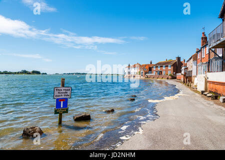 Rising tide flooding the seafront access road, Bosham, a south coast coastal village in Chichester Harbour, West Sussex, southern England, UK Stock Photo