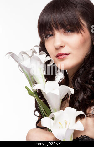 Woman holding flowers in hands in beauty portrait Stock Photo