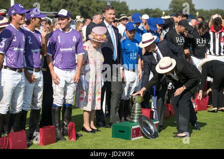 Queen Elizabeth II presents awards at the Cartier Queen's Cup polo tournament final at Guards Polo in Windsor Great Park, Berkshire. Stock Photo