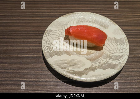 Otoro Tuna sushi, Japanese food raw fish on top of rice in white dish on wooden table Stock Photo