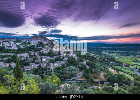 Rising sun over valley with Gordes town on hill top, Provence,France Stock Photo