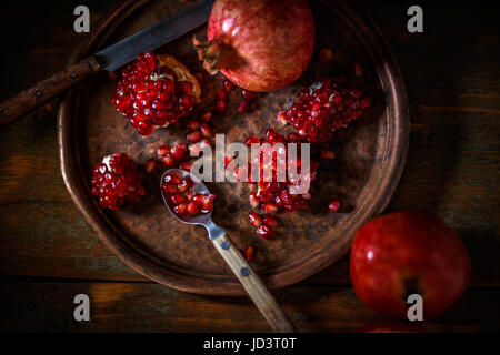 Broken and whole red ripe juicy pomegranates Stock Photo