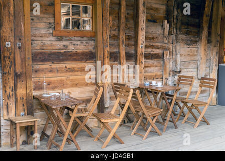 BERGEN, NORWAY - 1 JUNE , 2017: Tables and chairs outside a bar in an alley of the old Hanseatic city Stock Photo