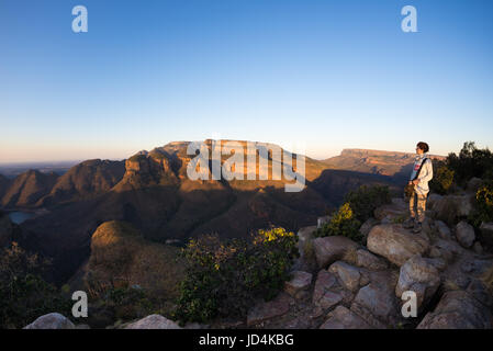 Blyde River Canyon, travel destination in South Africa. Tourist looking at panorama. Last sunlight on the mountain ridges. Fisheye distorted view from Stock Photo