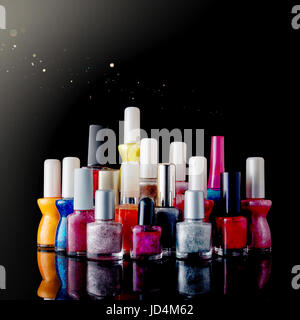 Nail polish, varnishes on black background. Assorted, unbranded. Stock Photo