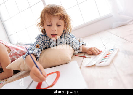 Cute skillful boy painting a picture Stock Photo