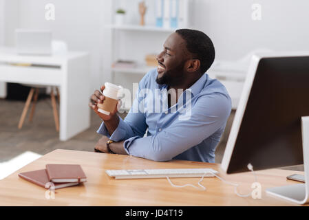 Happy positive man holding a cup of coffee Stock Photo