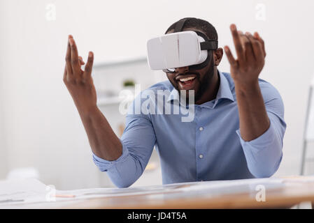 Positive delighted man using modern technology Stock Photo