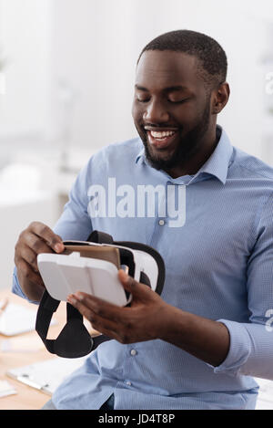 Delighted nice man being exited about new technology Stock Photo