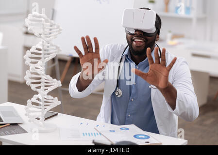 Nice male doctor being in the virtual reality Stock Photo