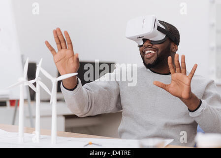 Joyful male environmentalist being in virtual reality Stock Photo