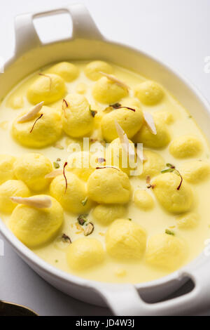 Angoori rasmalai or anguri ras malai is an Indian dessert. Made from cottage cheese which is then soaked in chashni, a sugary syrup, and rolled in fin Stock Photo