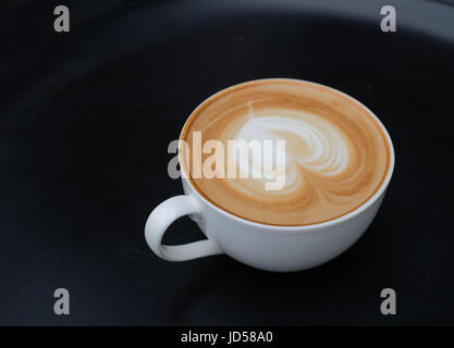 Latte art coffee. Heart shape latter art in white cup Stock Photo