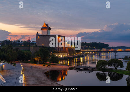 Opposition of two medieval fortresses on the river Narva at sunset, Estonia and Russia border Stock Photo