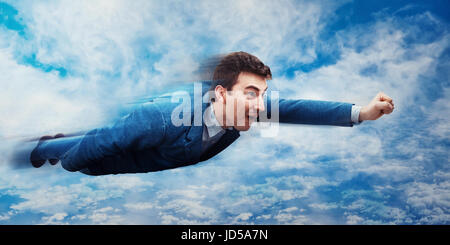 Wondered businessman flying above the clouds like a superhero. Business success, opportunity and risk concept. Stock Photo