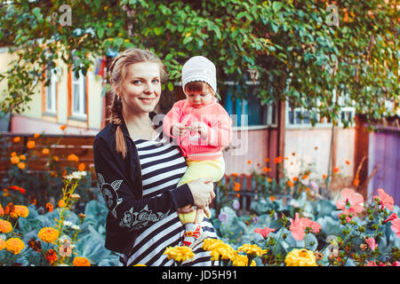 Mother and daughter working in the garden Stock Photo