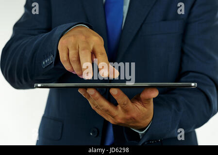 Photo of an elegant businessman working on a digital tablet in the office. Stock Photo