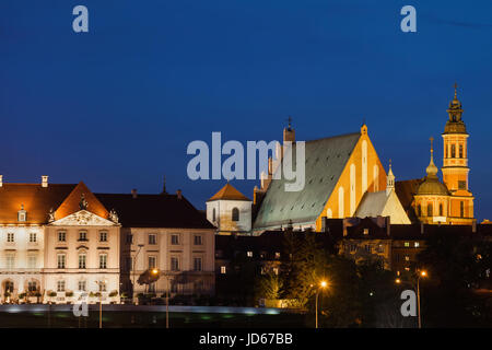 Poland, city of Warsaw, Old Town skyline at night with Royal Castle, St. John's Archcathedral and Shrine of Our Lady of Grace tower Stock Photo