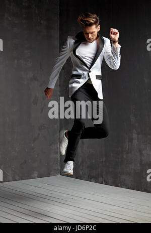 Handsome young man dancing on the wooden floor Stock Photo