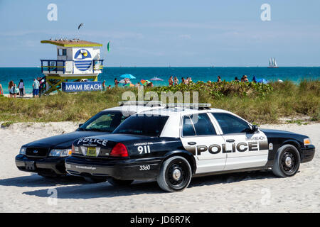 Miami Beach Florida,Atlantic Ocean,dune,water,lifeguard tower station,police car,cars,patrol,public safety,law enforcement,parked on sand,FL170331189 Stock Photo