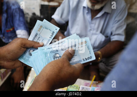 Dhaka, Bangladesh. 18th June, 2017. A man is checking new money notes in the outcast of Dhaka. People give new money to a relative as a gift during Eid. Credit: Md. Mehedi Hasan/ZUMA Wire/Alamy Live News Stock Photo