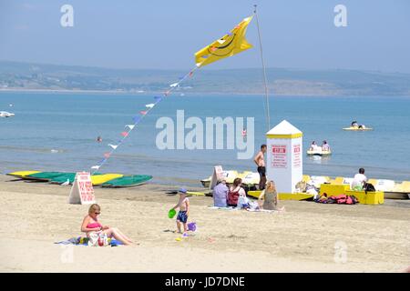 Weymouth, Dorset, UK. 19th June, 2017. Beach goers enjoy the hot weather on Weymouth beach as the Government issue a level three heat alert on a day where temperatures are expected to peak at 34C in parts of the UK bringing the hottest June day since 1976. Credit: Tom Corban/Alamy Live News Stock Photo