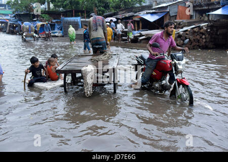 Dhaka, Bangladesh. 19th Jun, 2017. Bangladeshi children row a makeshift raft on a flooded road in Dhaka, Bangladesh, June 19, 2017. Encroachment of canals is contributing to the continual water logging in the Capital Dhaka. Credit: SK Hasan Ali/Alamy Live News Stock Photo