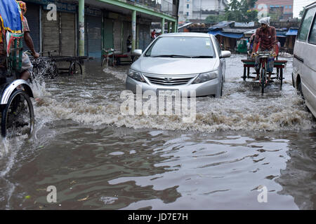 Dhaka, Bangladesh. 19th Jun, 2017.  Car pullers try to driving through a flooded street in Dhaka, Bangladesh, June 19, 2017. Encroachment of canals is contributing to the continual water logging in the Capital Dhaka. Credit: SK Hasan Ali/Alamy Live News Stock Photo