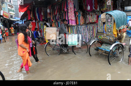 Dhaka, Bangladesh. 19th Jun, 2017.  Rickshaw pullers try to driving through a flooded street in Dhaka, Bangladesh, June 19, 2017. Encroachment of canals is contributing to the continual water logging in the Capital Dhaka. Credit: SK Hasan Ali/Alamy Live News Stock Photo